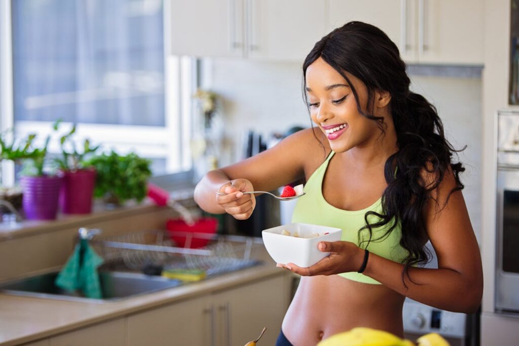 uma mulher na cozinha comendo.