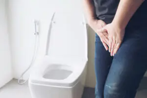 uma mulher sentindo dor por infecção urinária